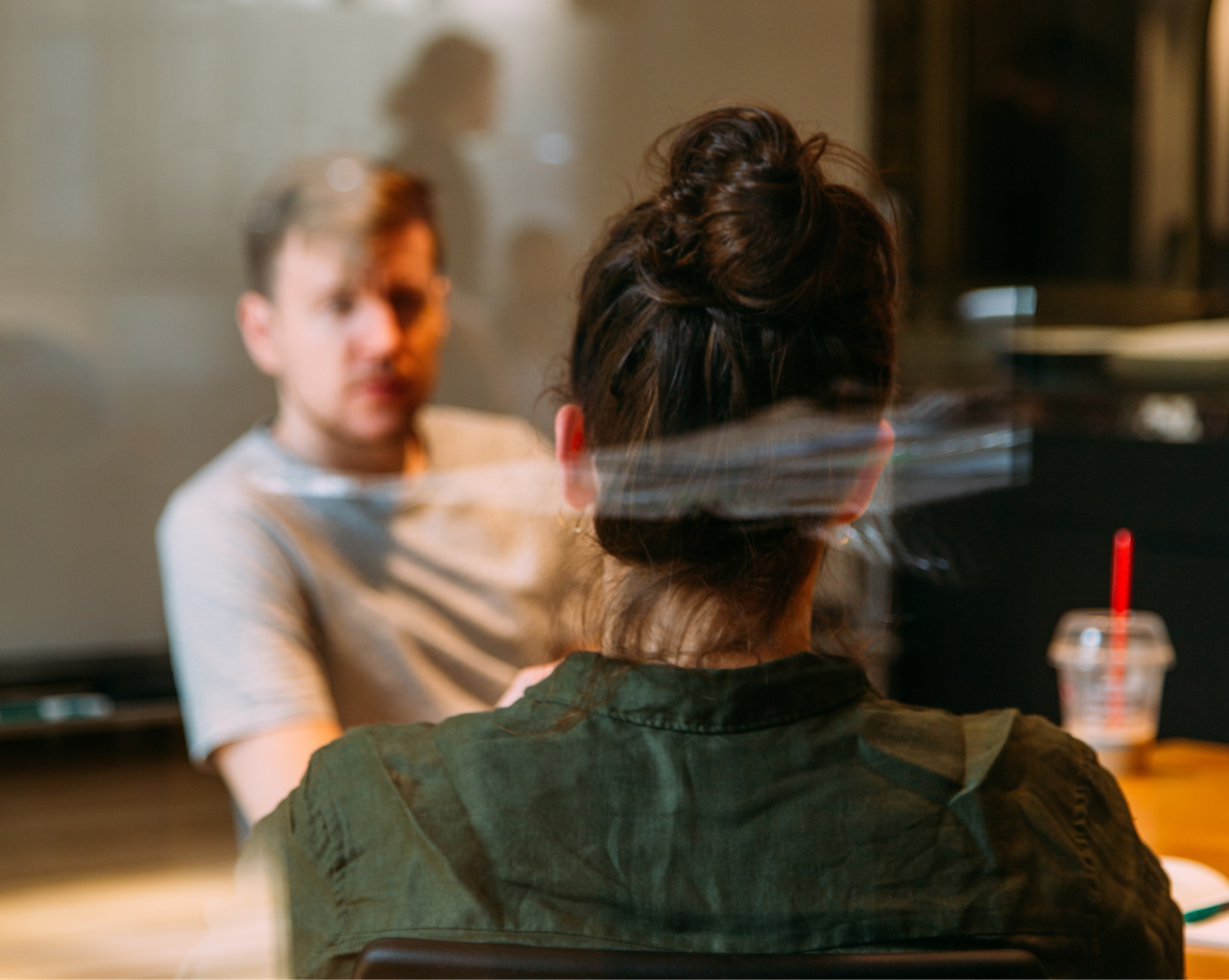 A woman and a man talking in a office